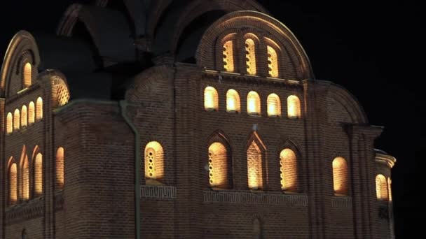 Church in the evening with luminous windows — Stock Video