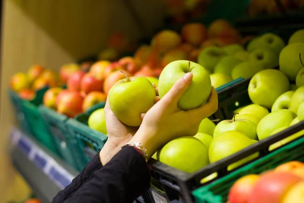 Female hands holding apples in their hand