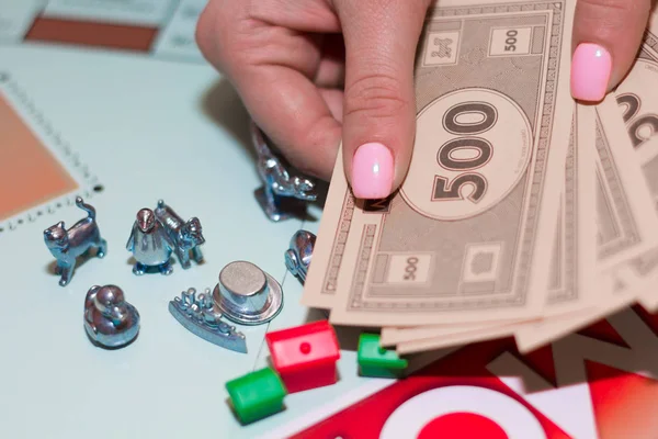 Monopoly game with dice, chips close-up.