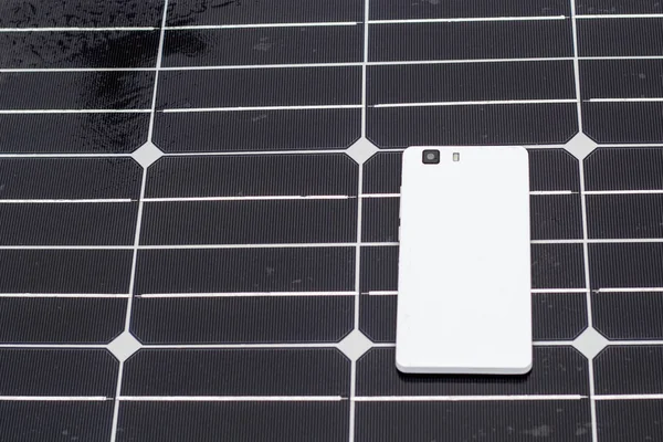 mobile phone on a solar panel outdoor close up