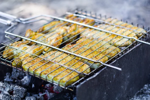 Cooking meat on the grill in the open air on the fire — Stock Photo, Image