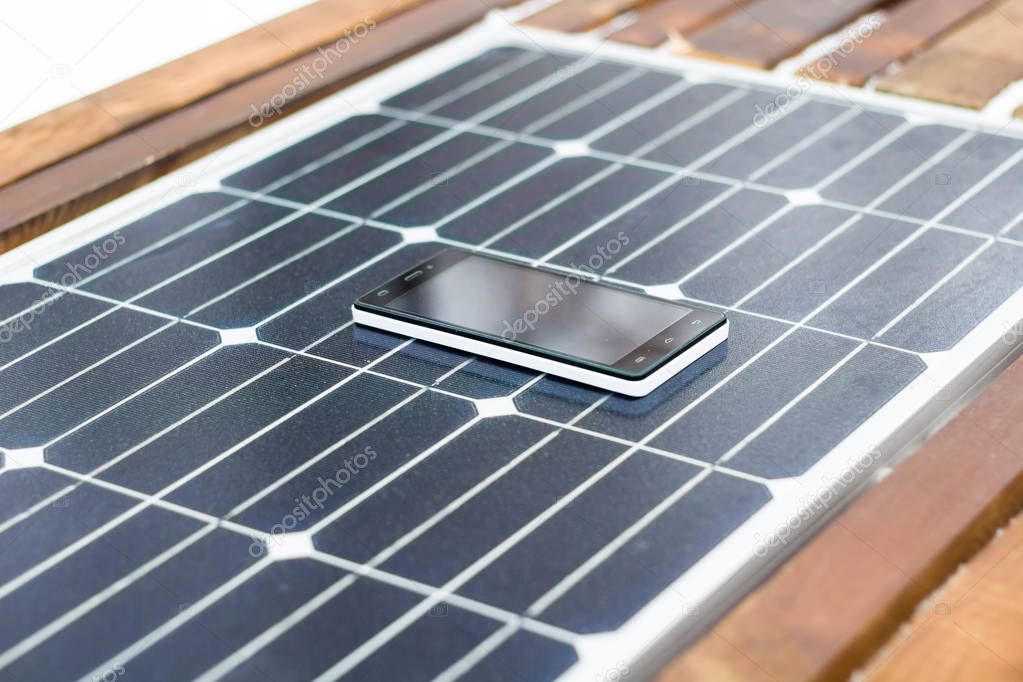 mobile phone on a solar panel outdoor close up