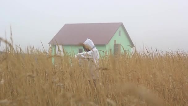 Cheerful Ghost in the fog in a balaclava near an abandoned house — Stock Footage Cheerful Ghost in the fog in a balaclava near an abandoned house Video Clip