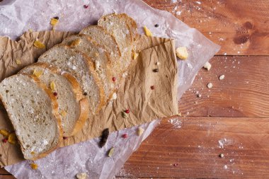 Taze ve güzel kokulu beyaz ekmek dilimlenmiş ve bir ahşap zemin üzerine yalancı. Biraz baharat kendisine eklenmiş ve aynı zamanda kraft kağıt üzerinde yatıyor. Gluten-Alerjik. Kavramsal gıda fotoğraf.