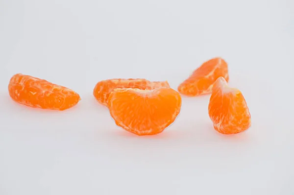 Mandarin slices on a white background, macro, space for copy — Stock Photo, Image