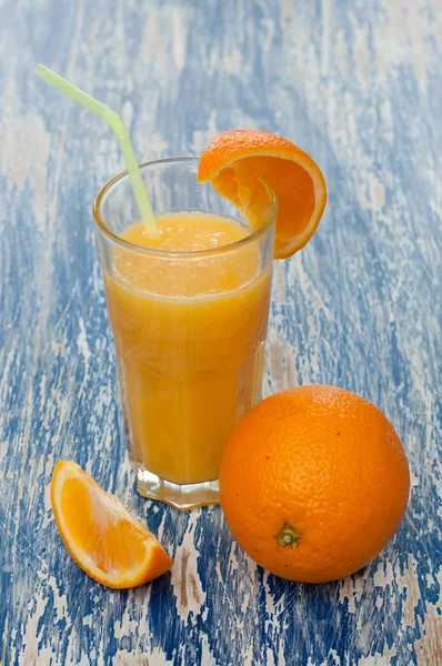 Orange juice cocktail in glass with a straw — Stock Photo, Image