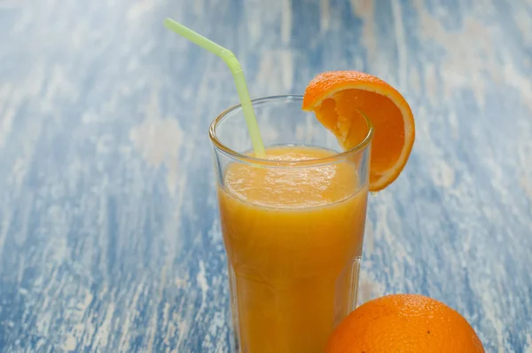 Orange juice cocktail in glass with a straw — Stock Photo, Image