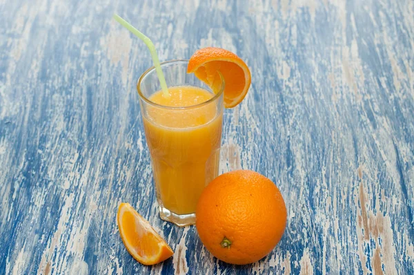 Orange juice cocktail in glass with a straw — Stock Photo, Image