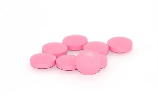 Tabletten von rosa Farbe auf weißem Hintergrund, gibt es einen Platz für Text. — Stockfoto