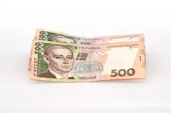 Pengar ukrainska hryvnia på en vit bakgrund, en stor bunt räkningar — Stockfoto