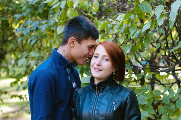 Love Story, um casal amoroso num parque da cidade. Um homem sussurra gentilmente ao seu ouvido à sua amada mulher. Foto em preto e branco, há um lugar para texto . — Fotografia de Stock