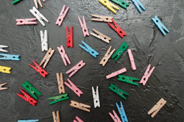 El yapımı arka plan, koyu gri beton üzerinde renkli ahşap clothespins çok, kopya alanı