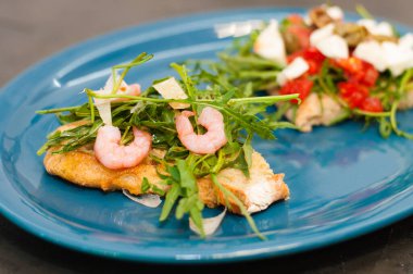 Karides, roka, domates, peynir ve sos, yakın plan yüksek İtalyan mutfağı.