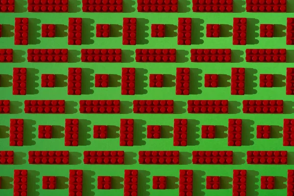 Small red details pattern from constructor on a green background