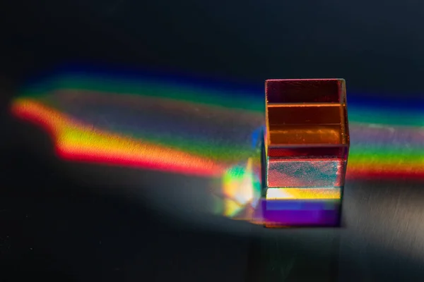 Colored square crystal on a gray surface