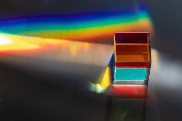 Colored square crystal on a gray surface