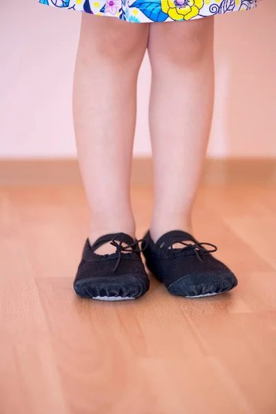 Unrecognizable child wearing dance shoes