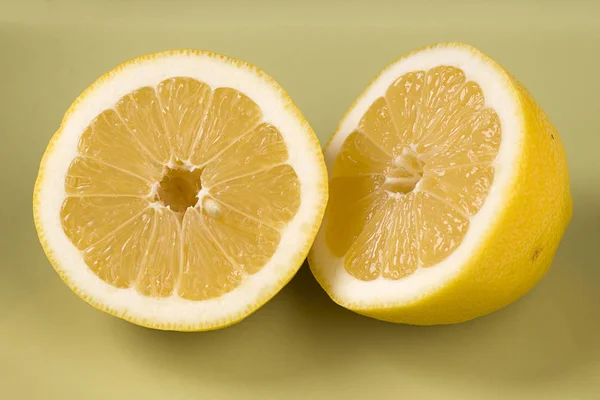 Lemon cut in half on a plate.