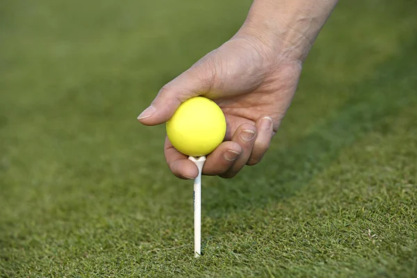 Het zetten van een bal en tee in de grond. — Stockfoto