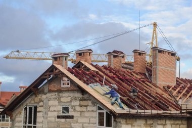 İnşaatta yüksek bir binanın çatısında.