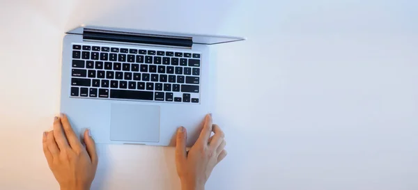 female hands on a opened laptop