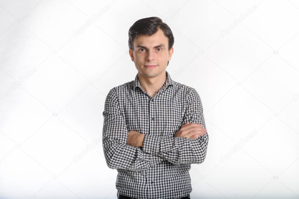 30-years brunet man in a grey outfit on a white background