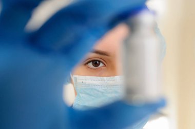 Kadın doktor elinde bir şişe beyaz ilaç tozu antibiyotik ve penisilin tutuyor..