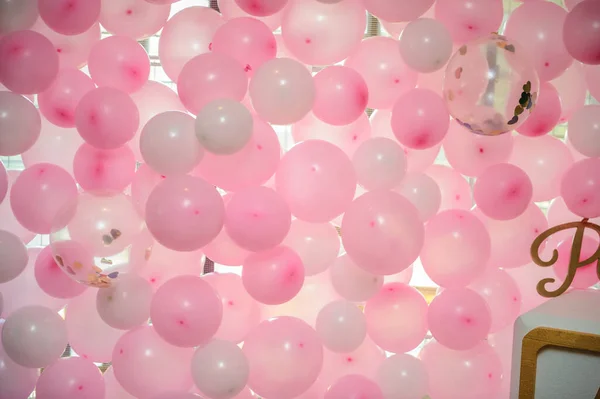 wall of pink balloons at a party