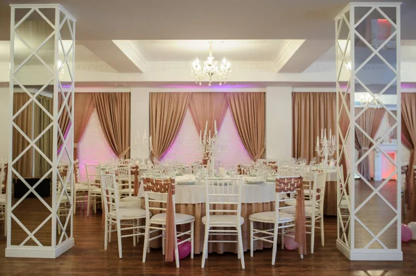 banquet hall in white and brown colors decorated for the event