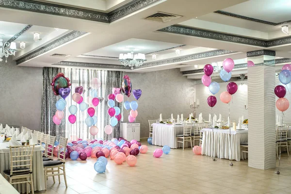 Restoranda pembe ve mavi balonlarla parti dekorasyonu.