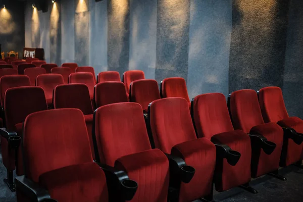close up photo of rows of red seats in the cinema/ concert hall cinema