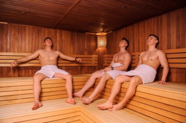 Rus saunasında dinlenen üç adamın yakın plan fotoğrafı. 