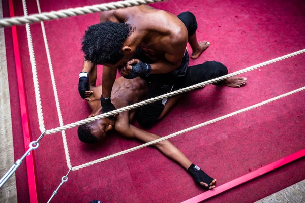 High angle view of African American fighter punching his opponent — Stock Photo, Image