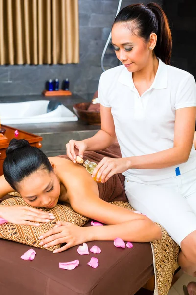 Beautiful Asian woman receiving massage — Stock Photo, Image