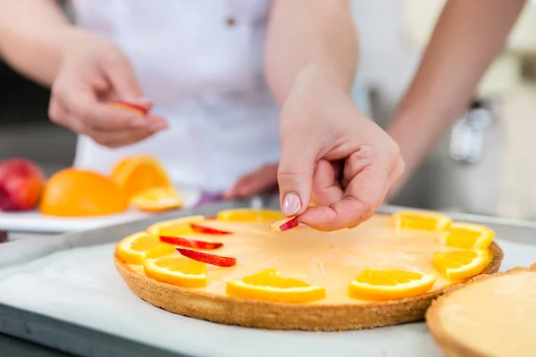 Fruit cakes being made by two pastry bakers — Stock Photo, Image