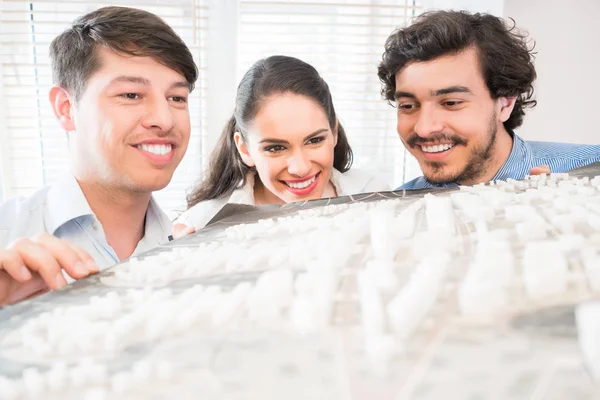 Architects with model for urban development — Stock Photo, Image