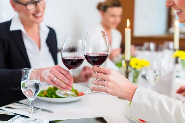 Mulheres no almoço de negócios brindar com vinho — Fotografia de Stock