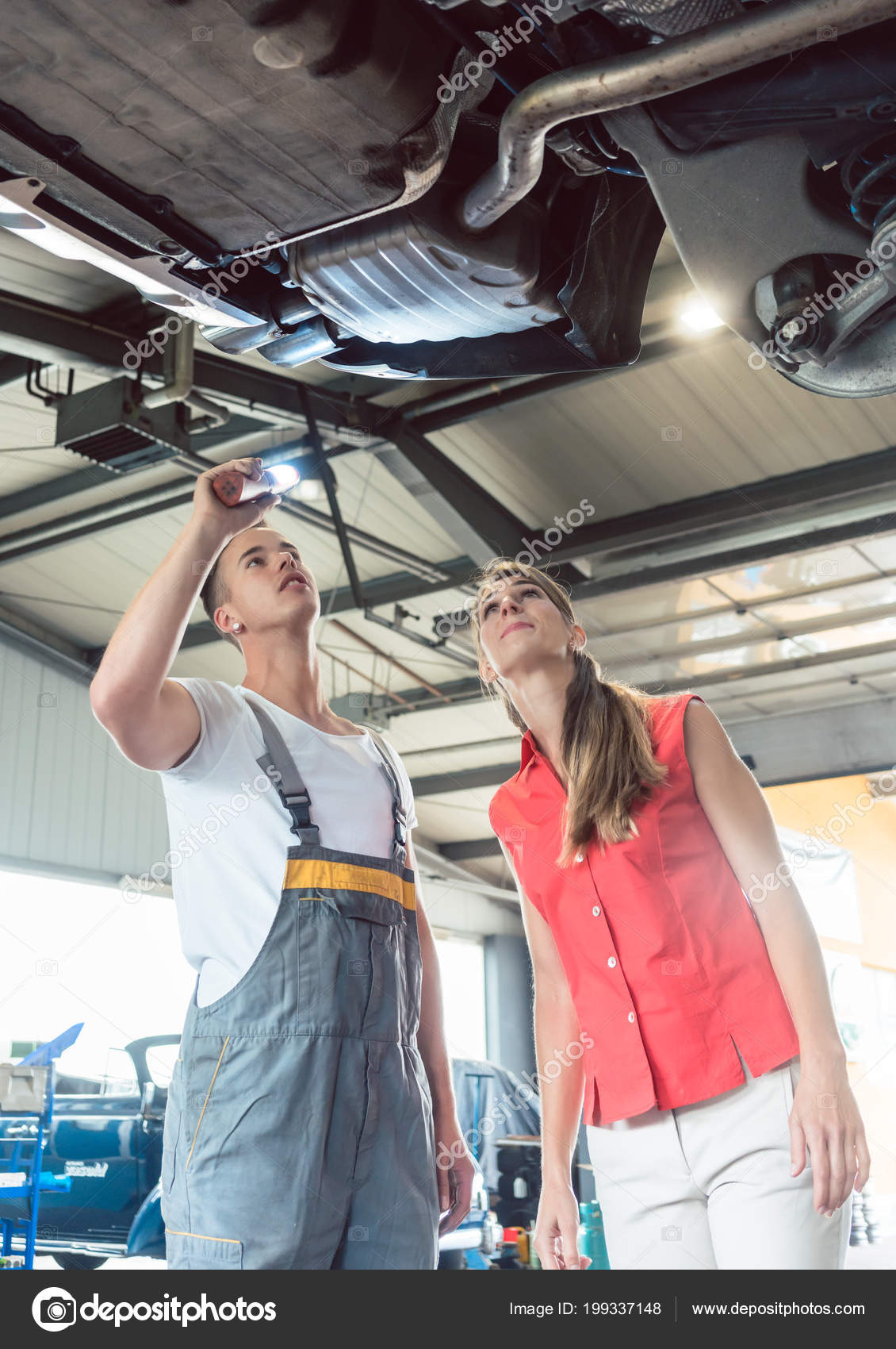 Reliable Auto Mechanics >> Reliable Auto Mechanic Checking The Car Of A Woman In A Reliable Auto Mechanics >> Reliable Auto Mechanic Checking The Car Of A Woman In A