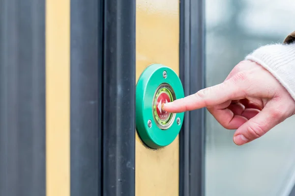 Woman pressing door opener in train — Stock Photo, Image