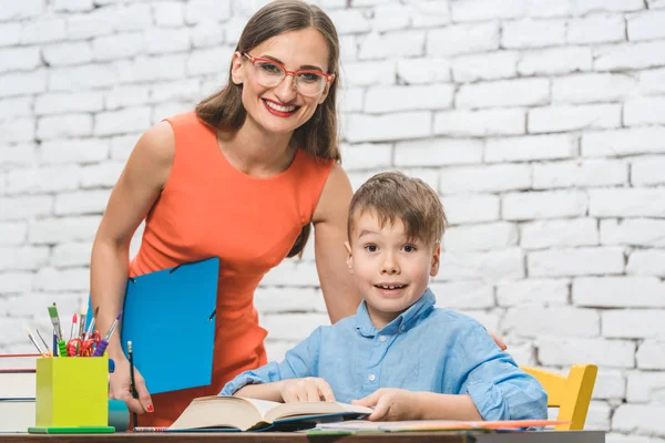 Teacher and pupil doing task together — Stock Photo, Image