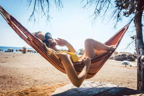 Woman lying in hammock close to the beach — Stock Photo, Image