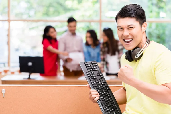 Young Chinese employee happy for his successful work on computer — Stock Photo, Image