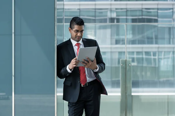 Indian businessman using a tablet PC indoors — Stock Photo, Image