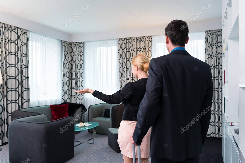 Man and woman arriving  in hotel room