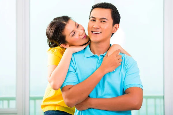 Young Asian couple cuddling together — Stock Photo, Image
