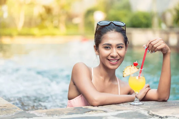 Porträt einer schönen asiatischen Frau, die einen Ananascocktail trinkt — Stockfoto