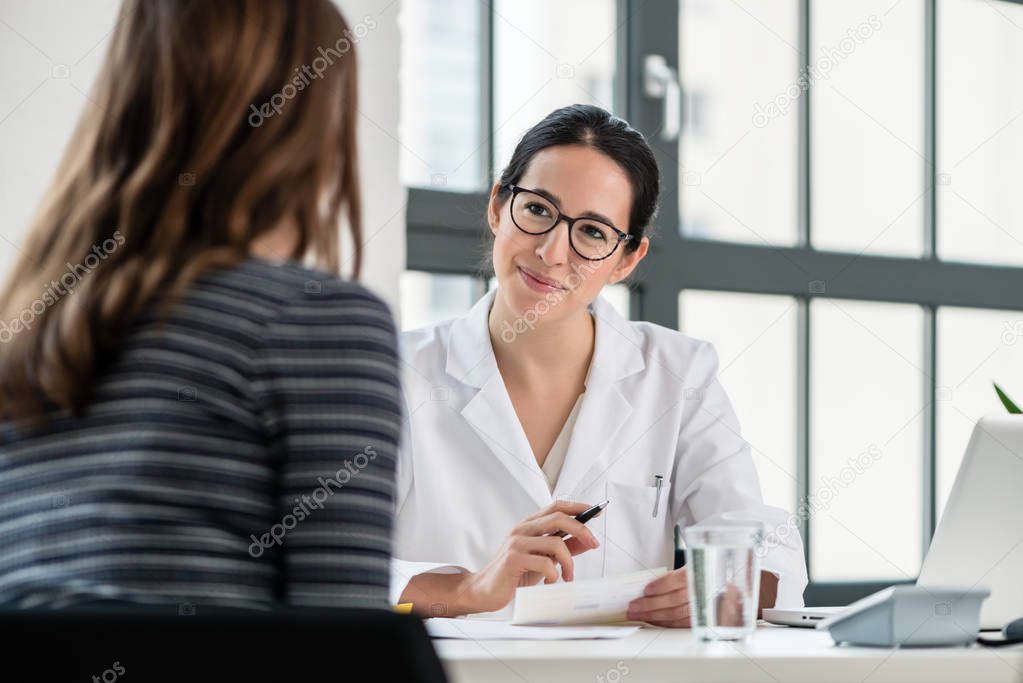 Female physician listening to her patient during consultation