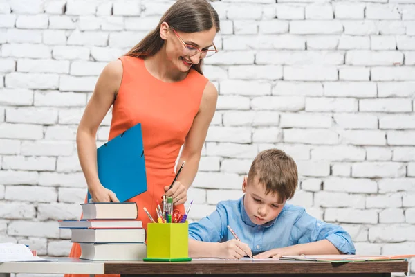 Teacher helping student with difficult task in school — Stock Photo, Image