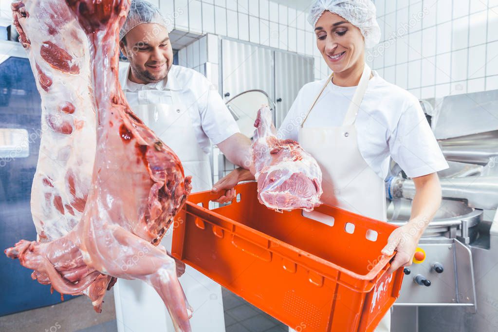 Team of butchers working with meat in butchery