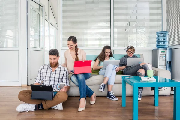 Young people sharing a collaborative office space in a modern hu — Stock Photo, Image
